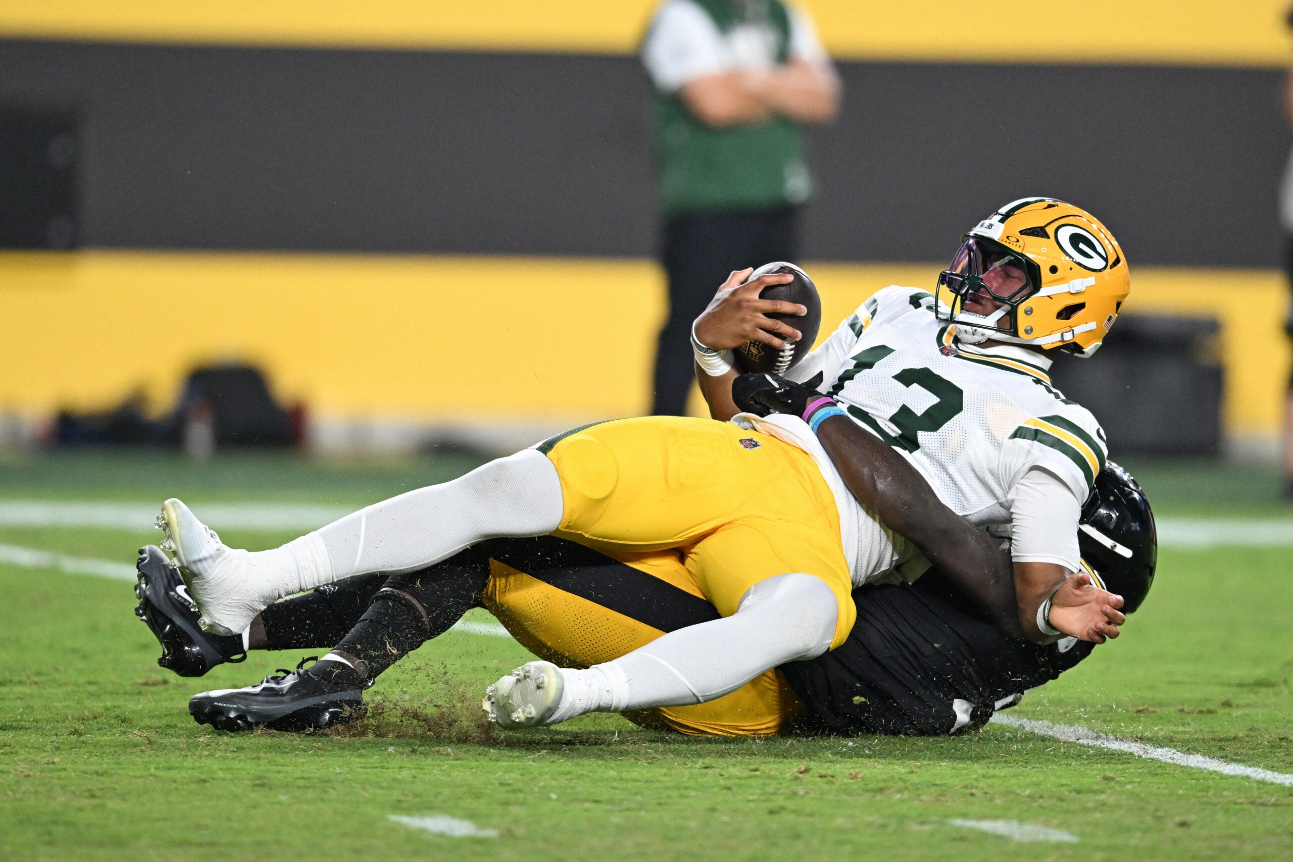 Aug 13, 2026; Pittsburgh, Pennsylvania, USA; Pittsburgh Steelers linebacker Jamin Davis (50) sacks Green Bay Packers quarterback Kyron Drones (13) during the second half at Acrisure Stadium.