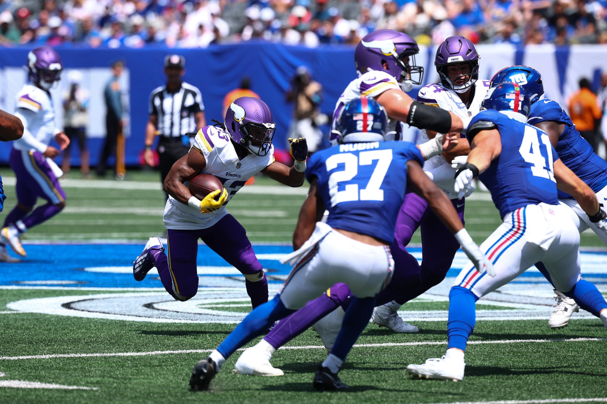 Aug 15, 2026; East Rutherford, New Jersey, USA; Minnesota Vikings running back Aaron Jones Sr. (33) carries the ball against the New York Giants during the first quarter at MetLife Stadium.