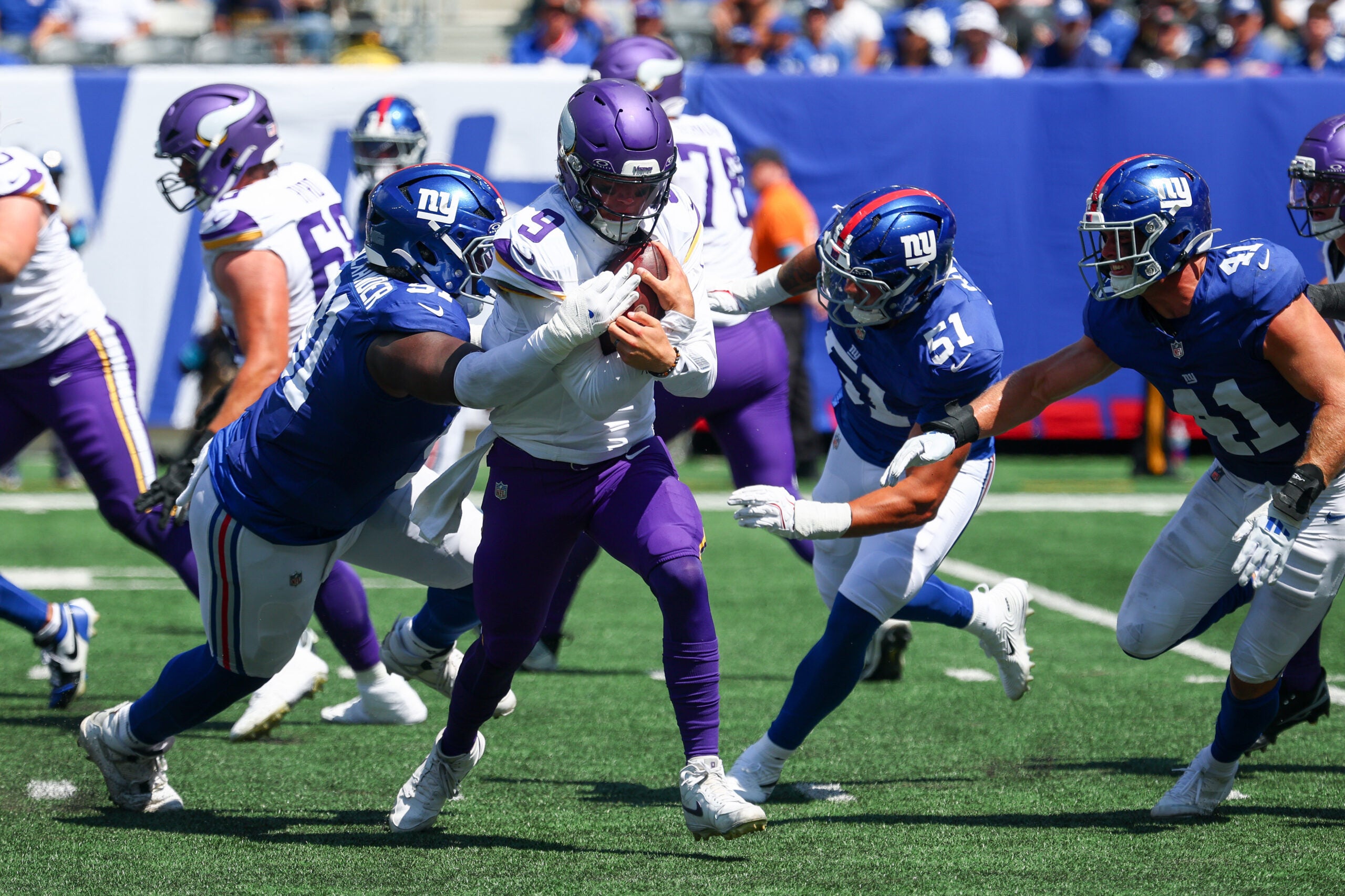 Aug 15, 2026; East Rutherford, New Jersey, USA; Minnesota Vikings quarterback J.J. McCarthy (9) is sacked by New York Giants defensive tackle Darius Alexander (91) during the first half at MetLife Stadium.
