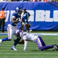 Aug 15, 2026; East Rutherford, New Jersey, USA; New York Giants running back Eric Gray (20) runs after a catch as Minnesota Vikings cornerback Dwight McGlothern (6) defends during the first half at MetLife Stadium.