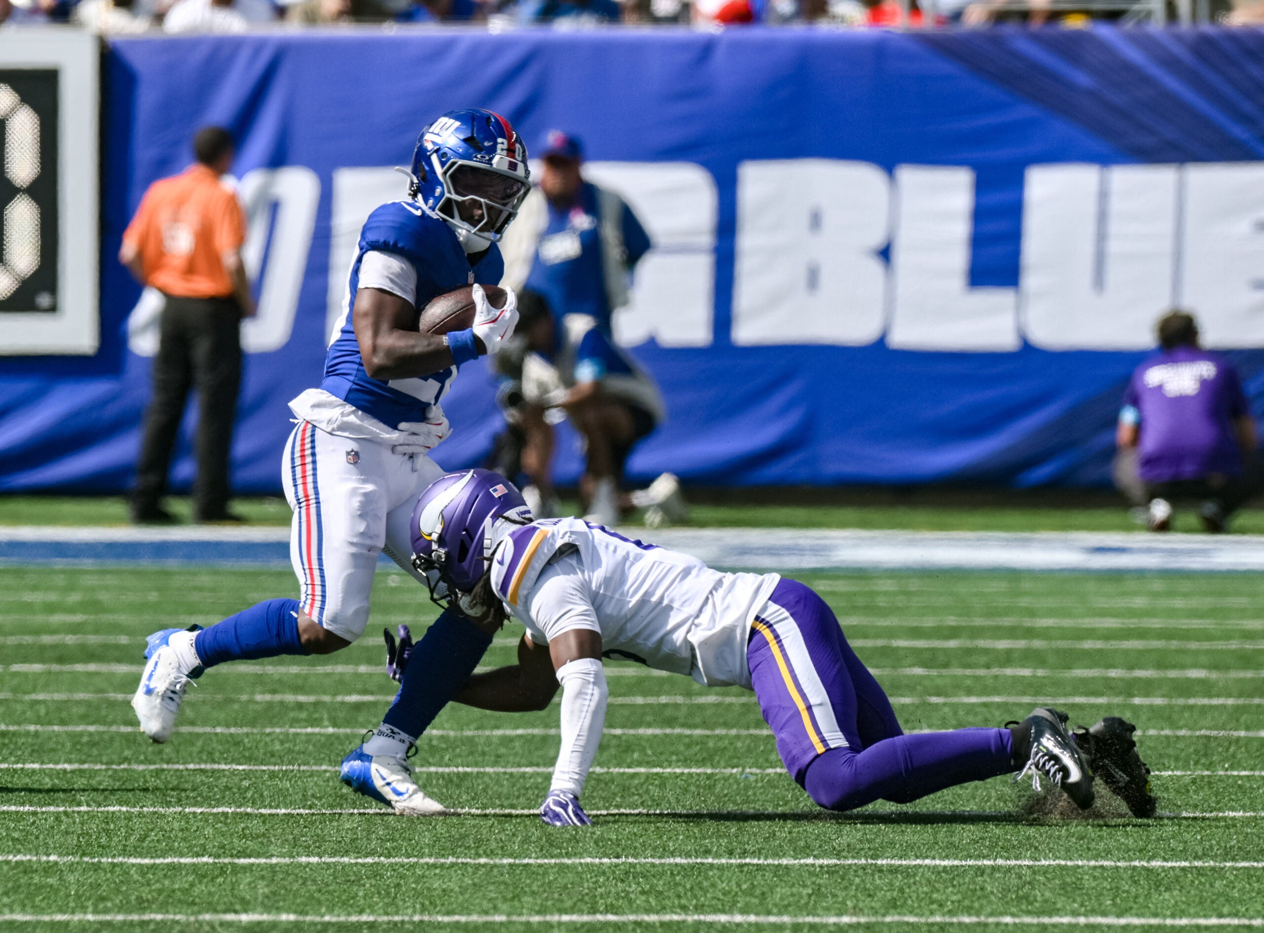 Aug 15, 2026; East Rutherford, New Jersey, USA; New York Giants running back Eric Gray (20) runs after a catch as Minnesota Vikings cornerback Dwight McGlothern (6) defends during the first half at MetLife Stadium.