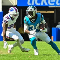 Aug 15, 2026; Orchard Park, New York, USA; Carolina Panthers running back Anthony Tyus III (34) tries to avoid Buffalo Bills linebacker Jimmy Ciarlo (35) after making a catch in the fourth quarter at the New Highmark Stadium.