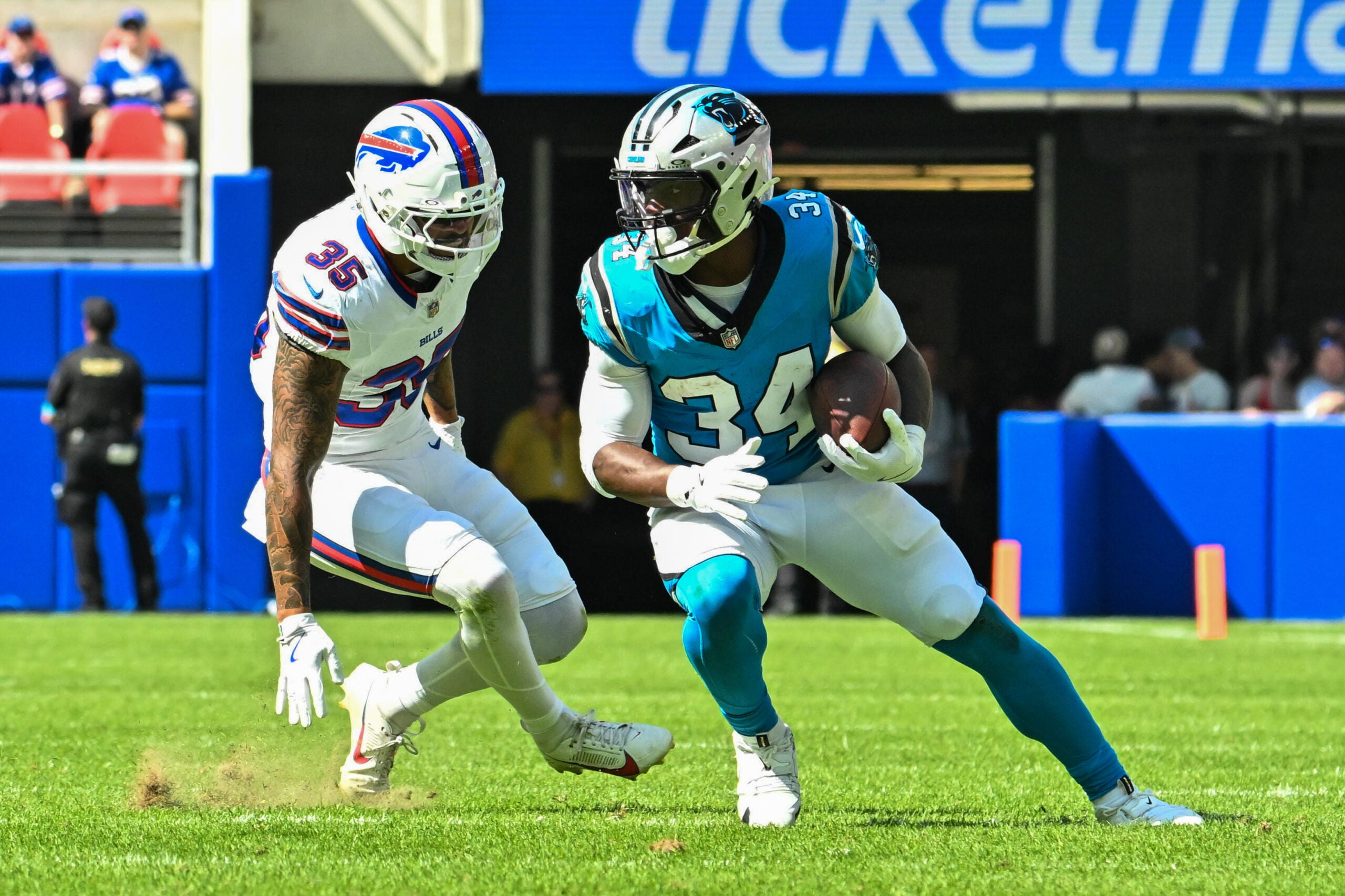 Aug 15, 2026; Orchard Park, New York, USA; Carolina Panthers running back Anthony Tyus III (34) tries to avoid Buffalo Bills linebacker Jimmy Ciarlo (35) after making a catch in the fourth quarter at the New Highmark Stadium.