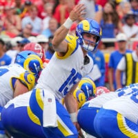 Aug 15, 2026; Kansas City, Missouri, USA; Los Angeles Rams quarterback Ty Simpson (15) signals at the line against the Kansas City Chiefs during the first half of the pre season game at Arrowhead Stadium.