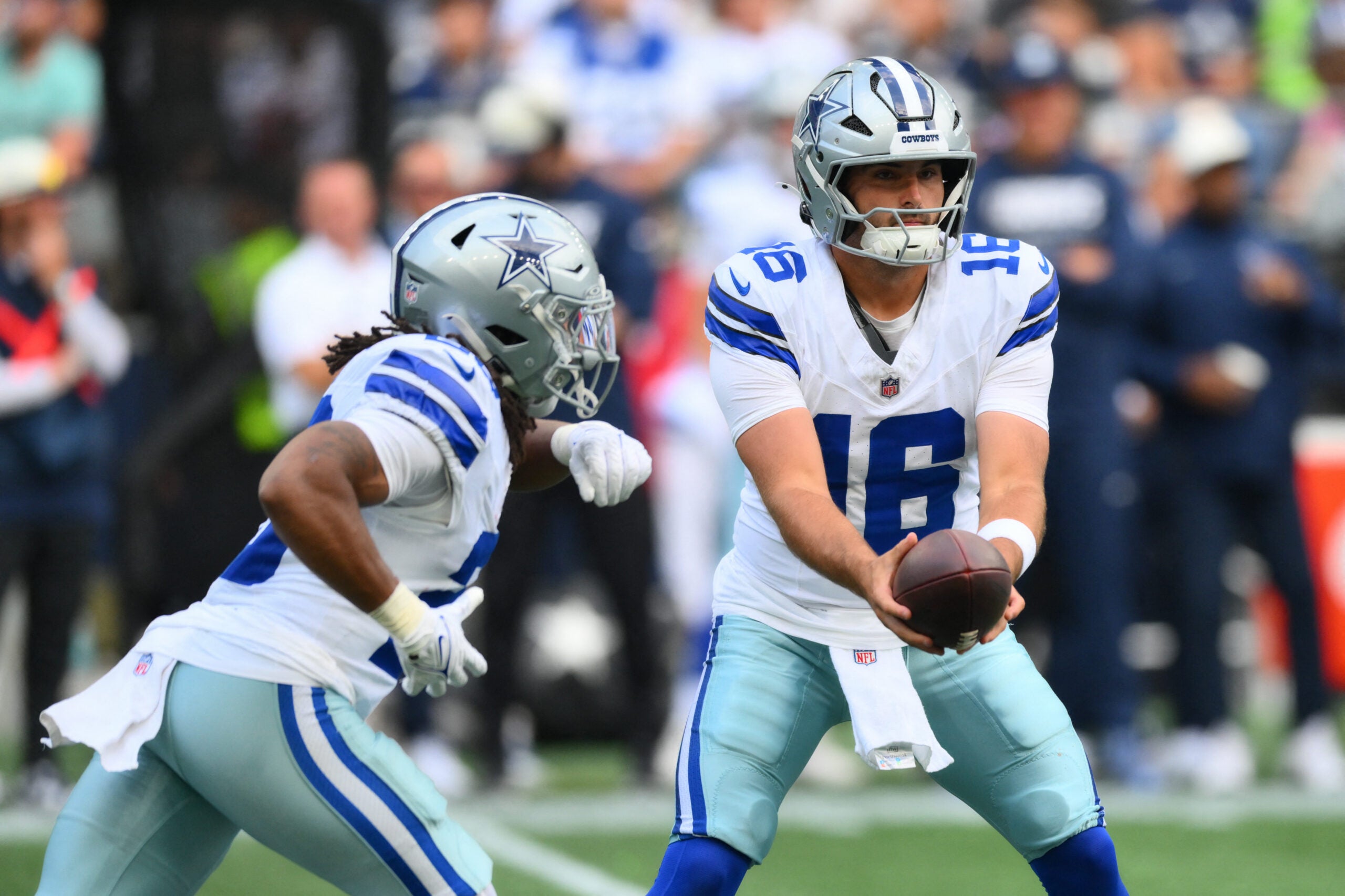 Aug 15, 2026; Seattle, Washington, USA; Dallas Cowboys quarterback Sam Howell (16) hands the ball off to Dallas Cowboys running back Jaydon Blue (23) during the first half at Lumen Field.
