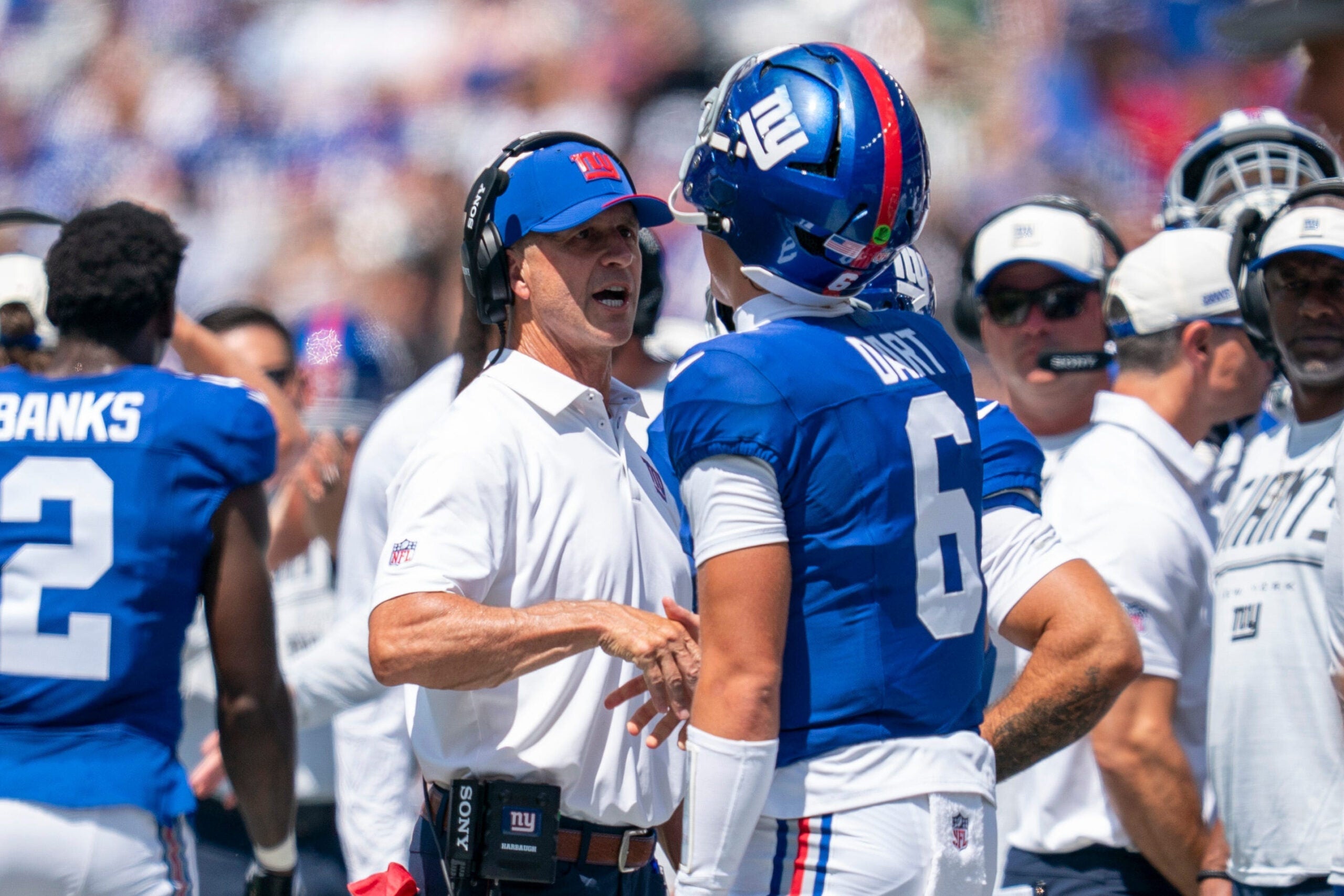 New York Giants head coach John Harbaugh chats with New York Giants quarterback Jaxson Dart (6) after a touchdown during a preseason opening game between the New York Giants and Minnesota Vikings on Saturday, Aug. 15, 2026, at MetLife Stadium in East Rutherford, NJ.