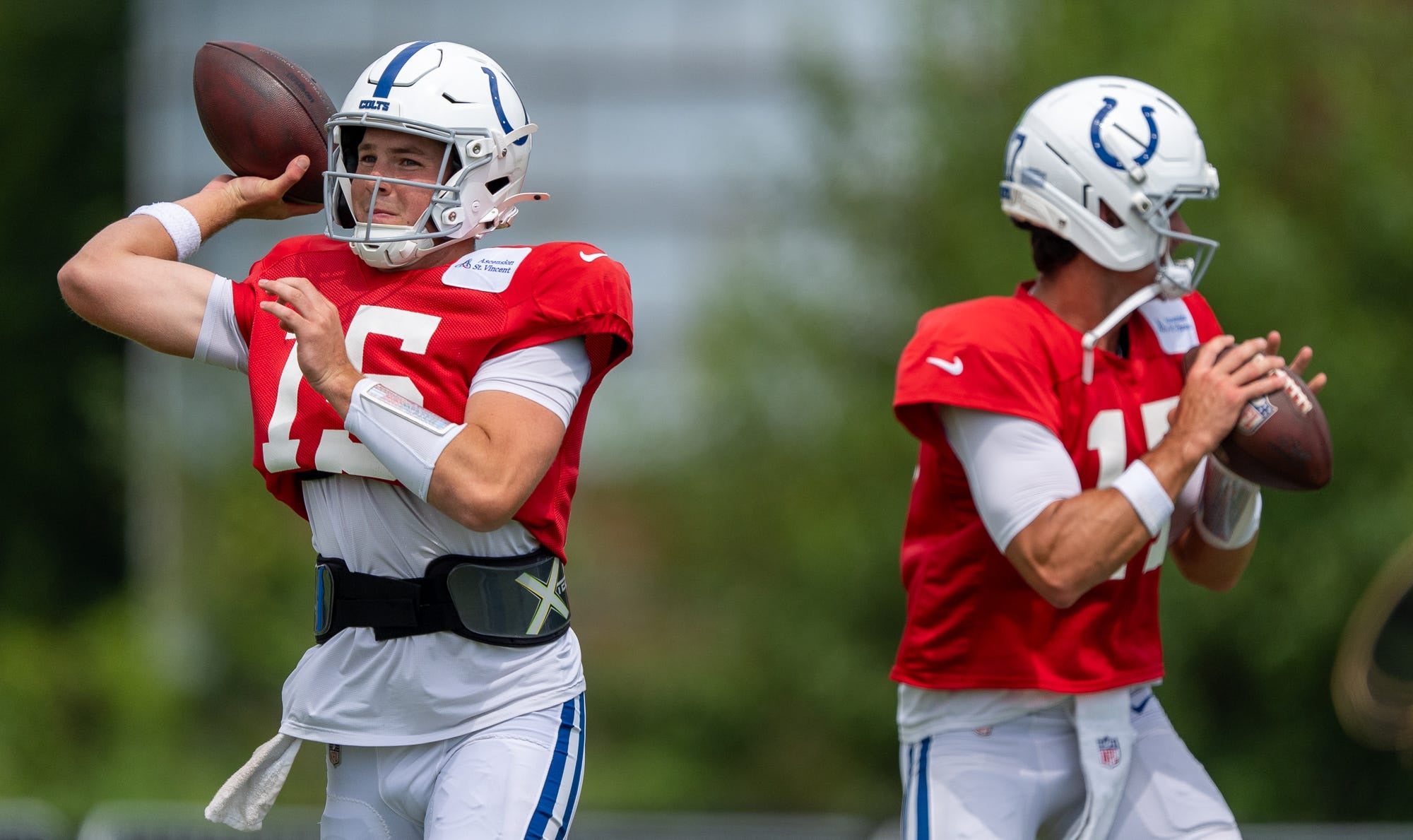 Indianapolis Colts quarterbacks Riley Leonard (15) and Daniel Jones (17) pass Wednesday, Aug. 19, 2026, during a joint practice with the Atlanta Falcons at Grand Park in Westfield.