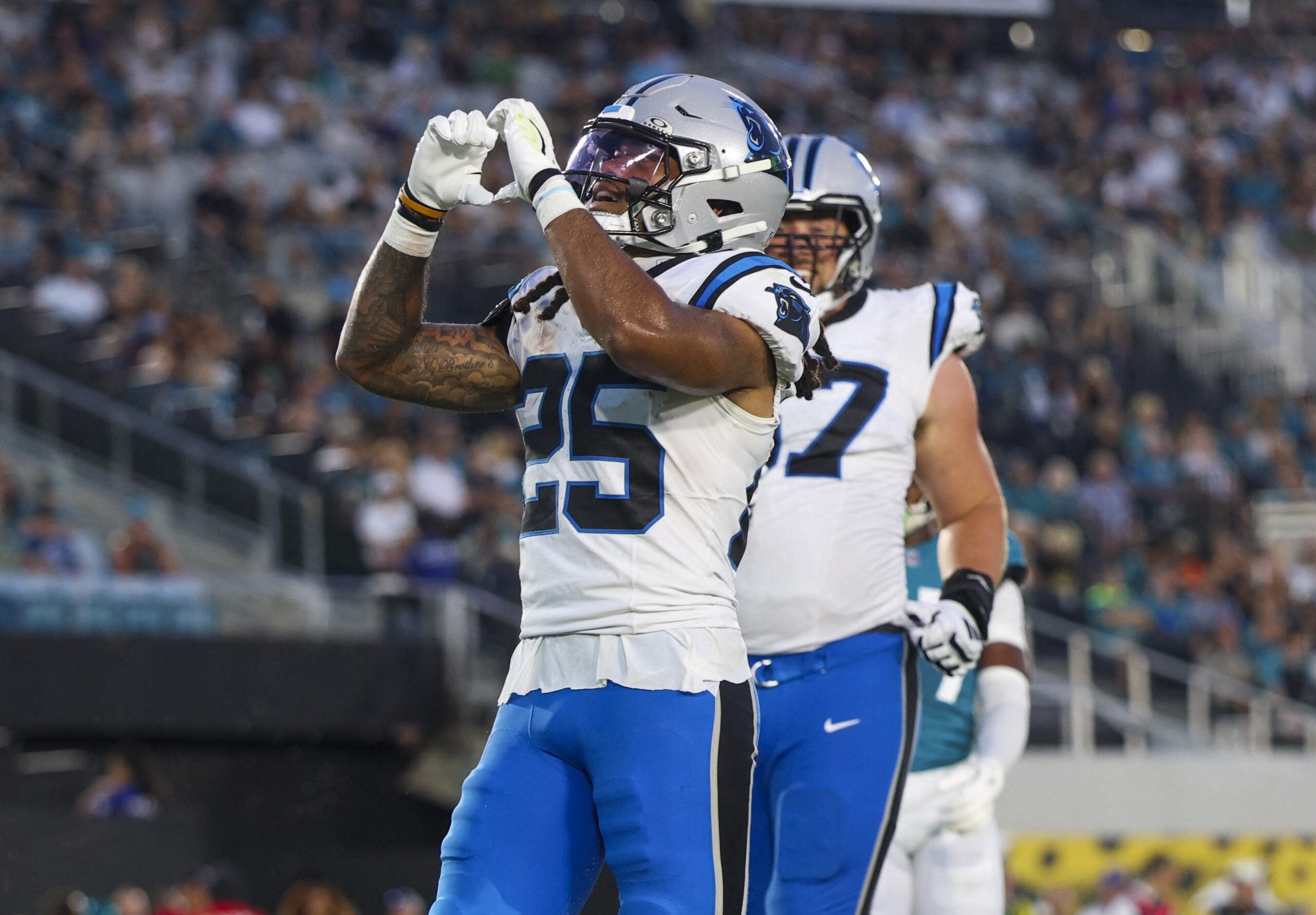 Carolina Panthers running back Jonathon Brooks (25) reacts after scoring a touchdown against the Jacksonville Jaguars in the first quarter during a preseason game at EverBank Stadium.