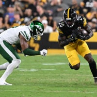 Aug 21, 2026; Pittsburgh, Pennsylvania, USA; Pittsburgh Steelers running back Kaleb Johnson (20) is tackled by New York Jets safety Andre Cisco (8) during the third quarter at Acrisure Stadium.