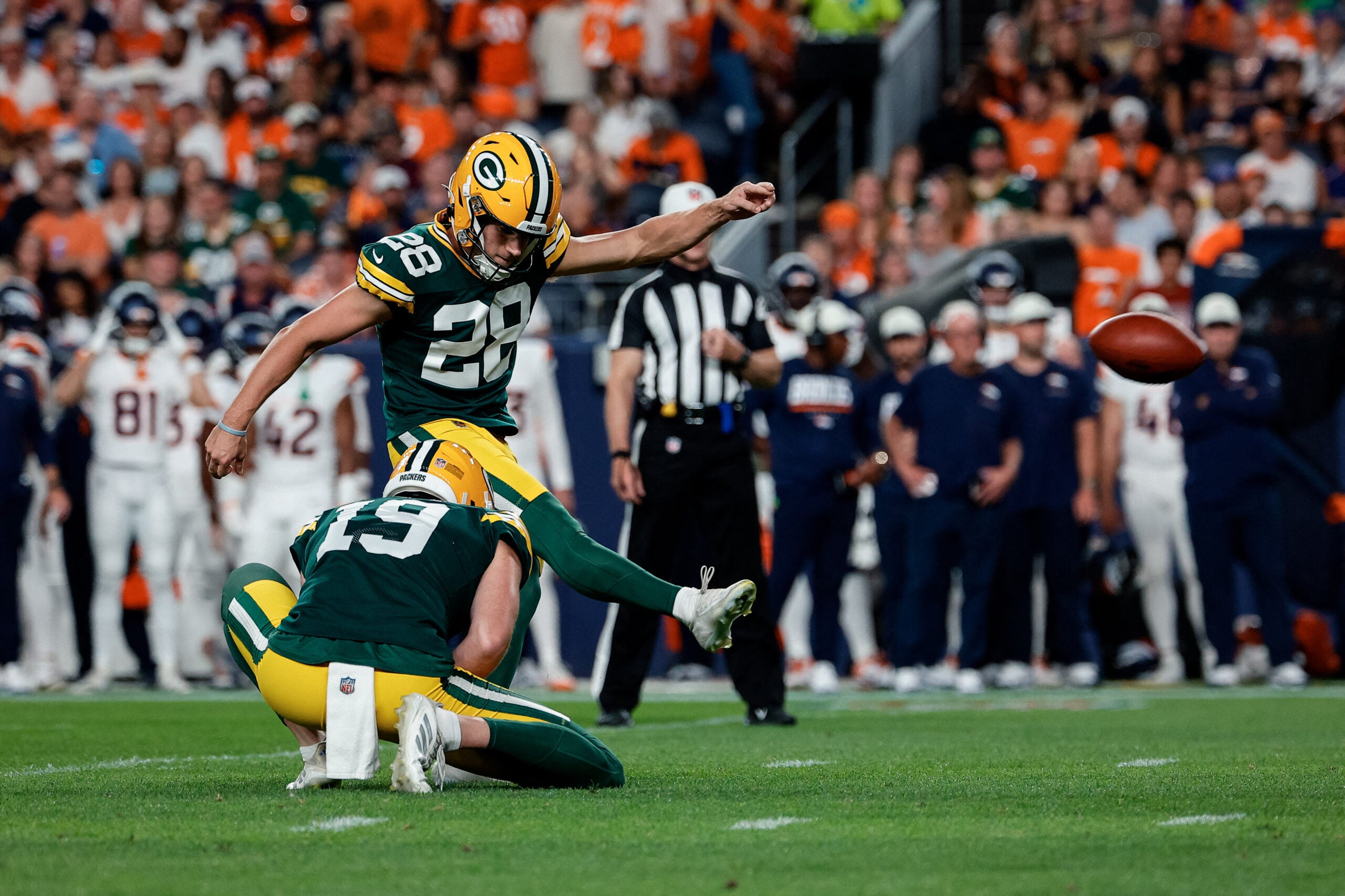 Aug 21, 2026; Denver, Colorado, USA; Green Bay Packers place kicker Trey Smack (28) kicks a point after on a hold from punter Daniel Whelan (19) in the second quarter against the Denver Broncos at Empower Field at Mile High.