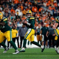 Aug 21, 2026; Denver, Colorado, USA; Green Bay Packers quarterback Kyle McCord (18) drops back in the fourth quarter against the Denver Broncos at Empower Field at Mile High.