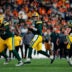 Aug 21, 2026; Denver, Colorado, USA; Green Bay Packers quarterback Kyle McCord (18) drops back in the fourth quarter against the Denver Broncos at Empower Field at Mile High.