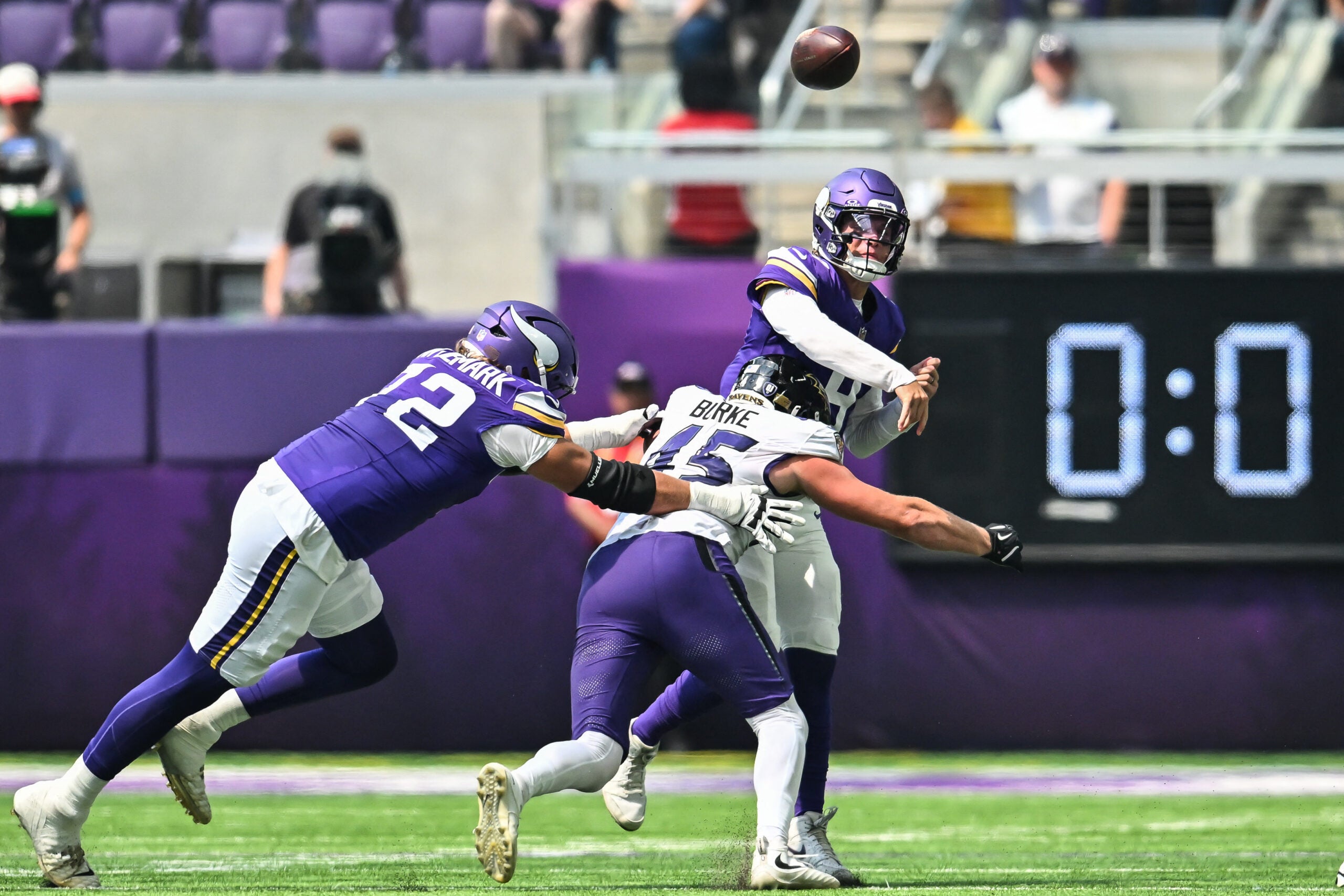 Aug 22, 2026; Minneapolis, Minnesota, USA; Minnesota Vikings quarterback J.J. McCarthy (9) is hit by Baltimore Ravens linebacker Ethan Burke (45) as offensive tackle Ryan van Demark (72) attempts to block during the second quarter at U.S. Bank Stadium.