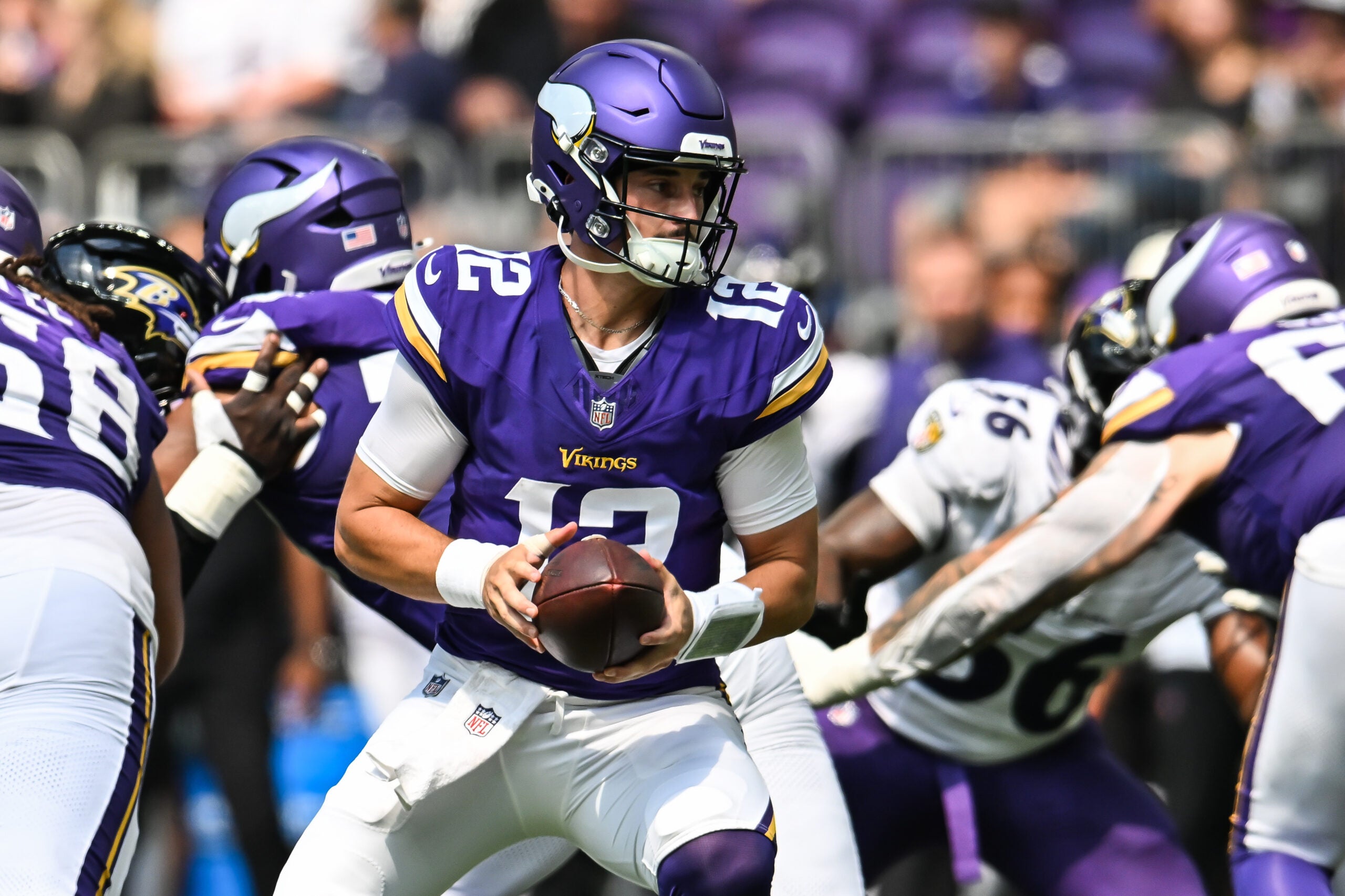 Aug 22, 2026; Minneapolis, Minnesota, USA; Minnesota Vikings quarterback Max Brosmer (12) looks to hand the ball off against the Baltimore Ravens during the third quarter at U.S. Bank Stadium.