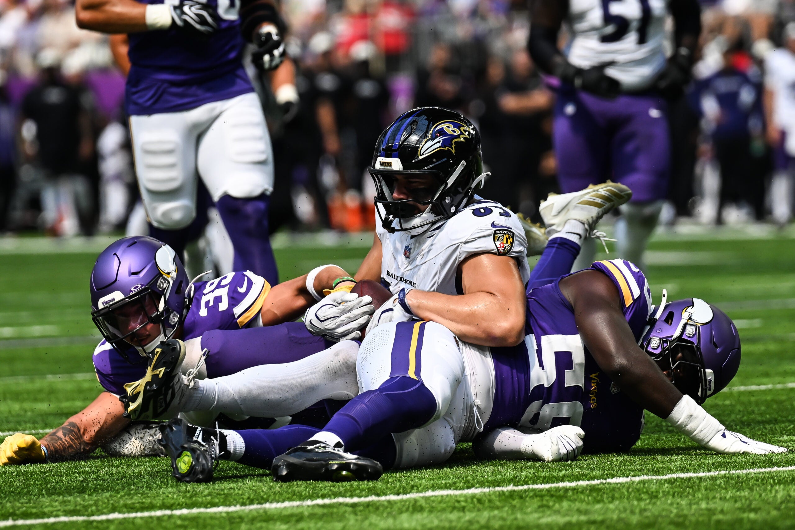 Aug 22, 2026; Minneapolis, Minnesota, USA; Baltimore Ravens tight end Josh Cuevas (85) is tackled by Minnesota Vikings safety Jacob Thomas (39) and linebacker Bangally Kamara (59) during the third quarter at U.S. Bank Stadium.