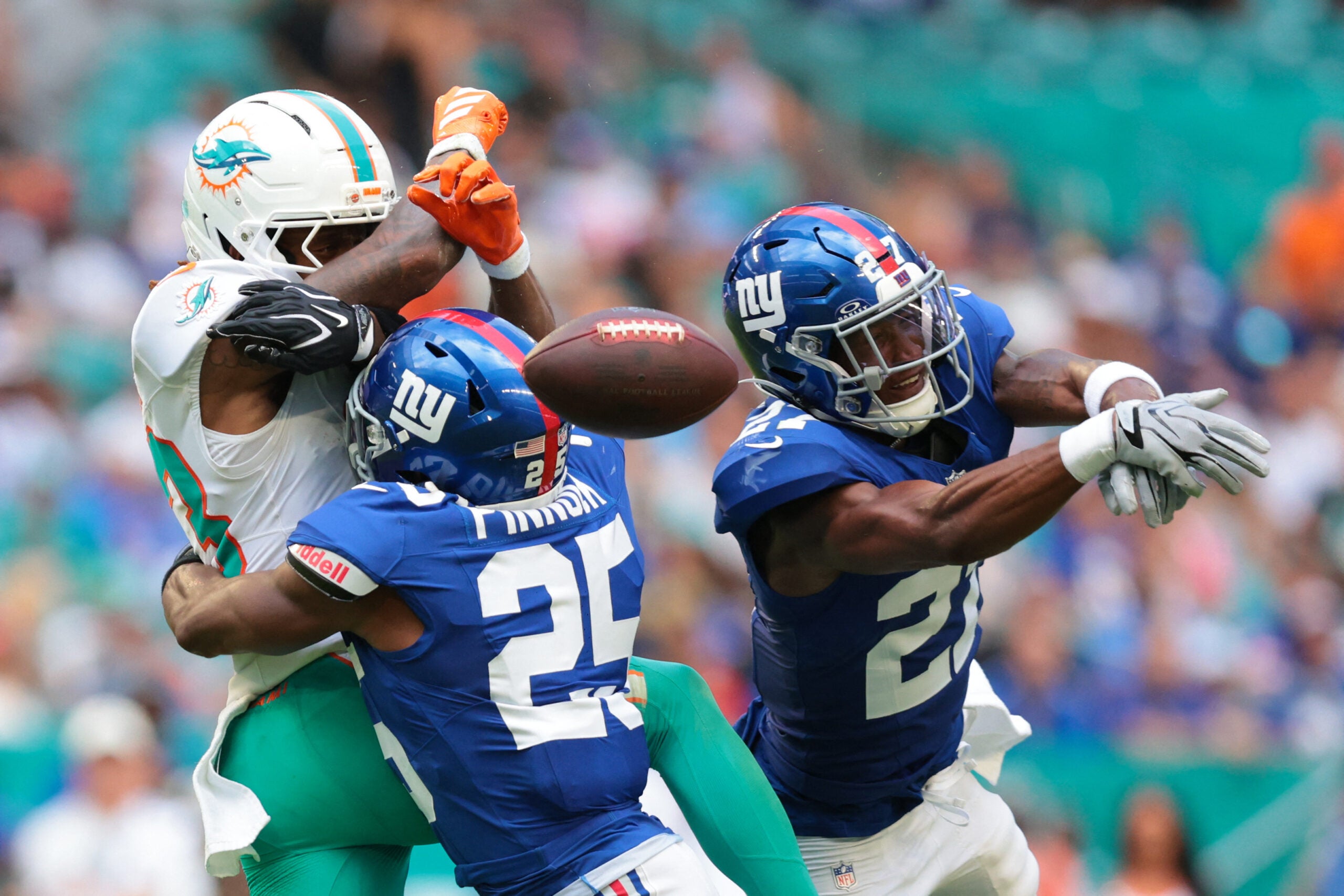 Aug 22, 2026; Miami Gardens, Florida, USA; New York Giants safety Tyler Nubin (27) and safety Jason Pinnock (25) defend against Miami Dolphins wide receiver Kevin Coleman Jr. (83) during the first half at Hard Rock Stadium.