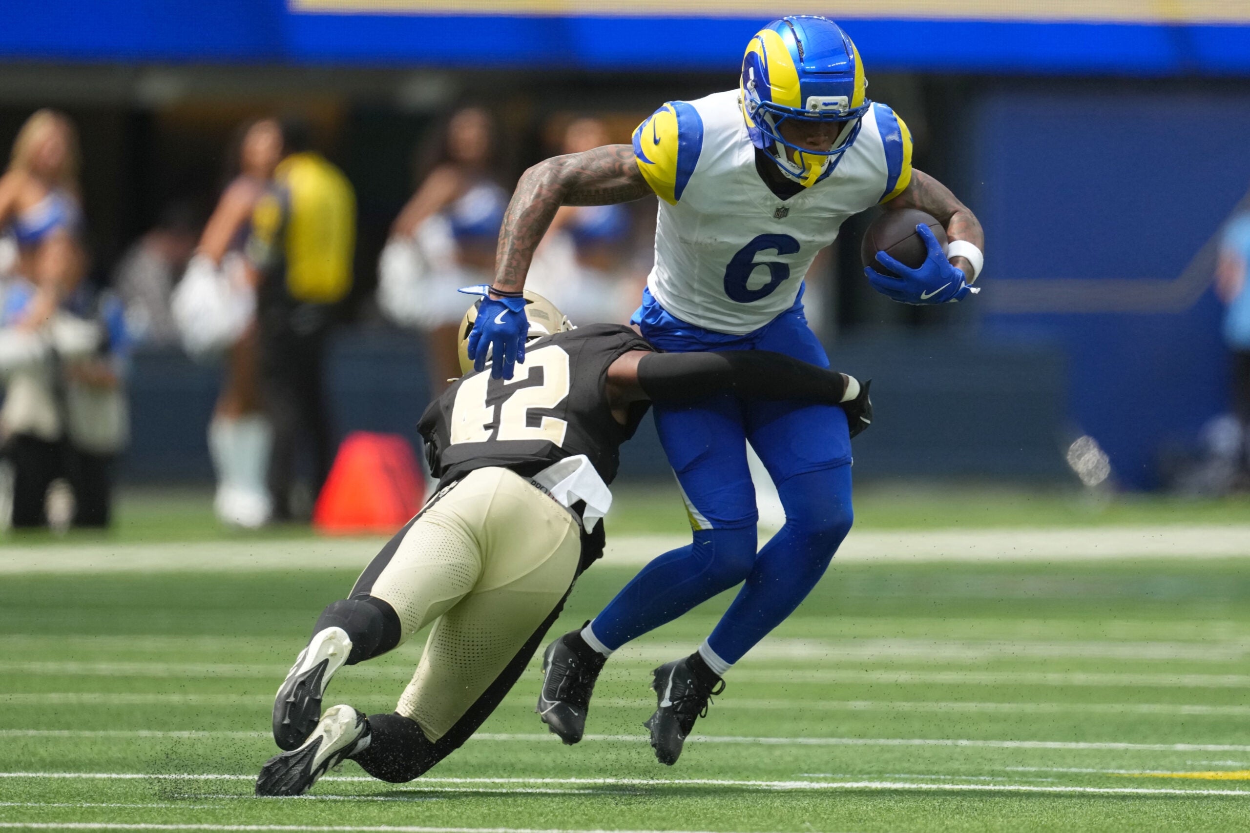 Aug 22, 2026; Inglewood, California, USA; Los Angeles Rams wide receiver CJ Daniels (6) carries the ball against 42 in the first half at SoFi Stadium.