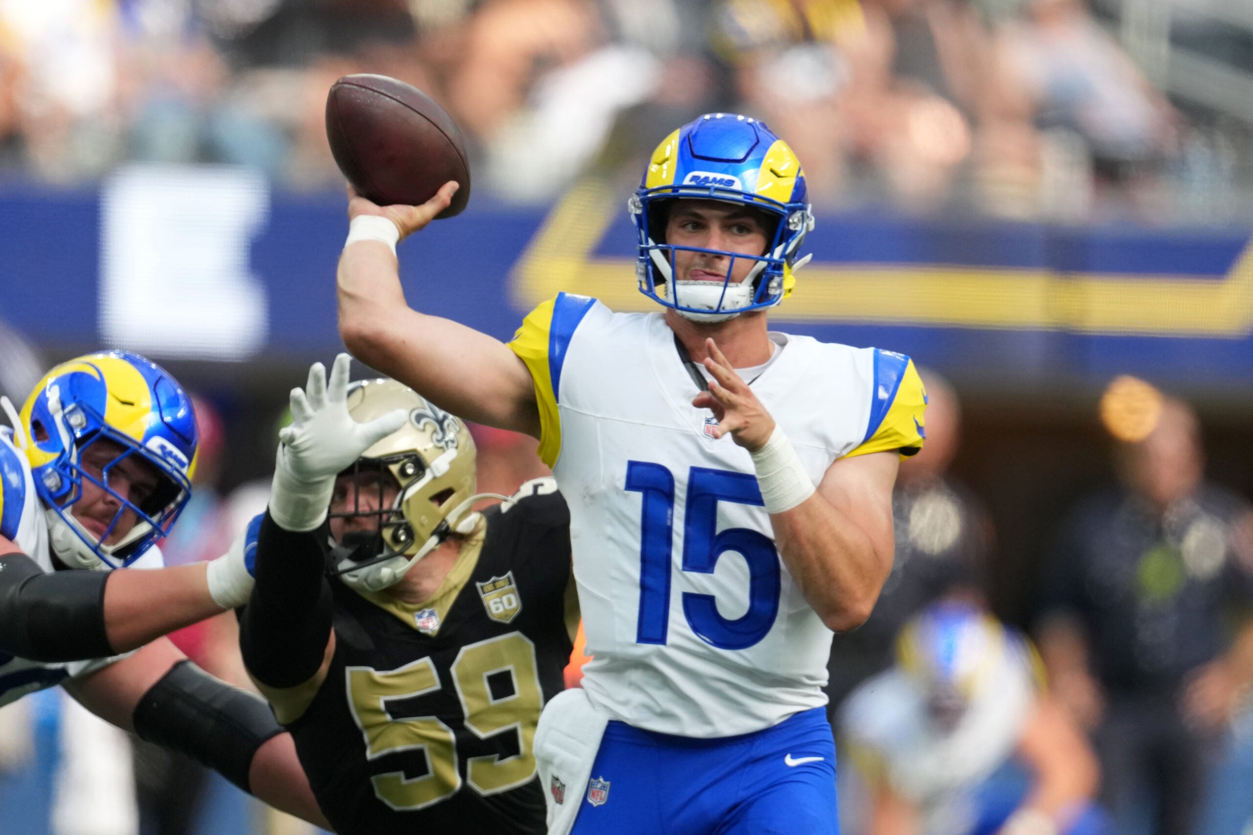 Aug 22, 2026; Inglewood, California, USA; Los Angeles Rams quarterback Ty Simpson (15) throws the ball against defensive Garrett Nelson (59) in the second half at SoFi Stadium.