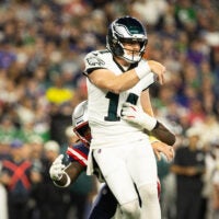 Aug 22, 2026; Foxborough, Massachusetts, USA; New England Patriots linebacker Gabe Jacas (50) tackles Philadelphia Eagles quarterback Andy Dalton (14) in the first half at Gillette Stadium.