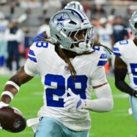 Aug 22, 2026; Glendale, Arizona, USA; Dallas Cowboys cornerback Shavon Revel Jr. (28) runs with the ball after intercepting a pass in the first half against the Arizona Cardinals at State Farm Stadium.