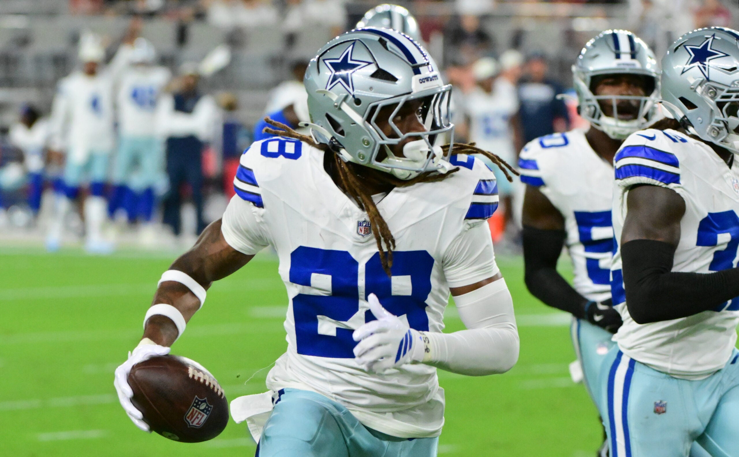 Aug 22, 2026; Glendale, Arizona, USA; Dallas Cowboys cornerback Shavon Revel Jr. (28) runs with the ball after intercepting a pass in the first half against the Arizona Cardinals at State Farm Stadium.