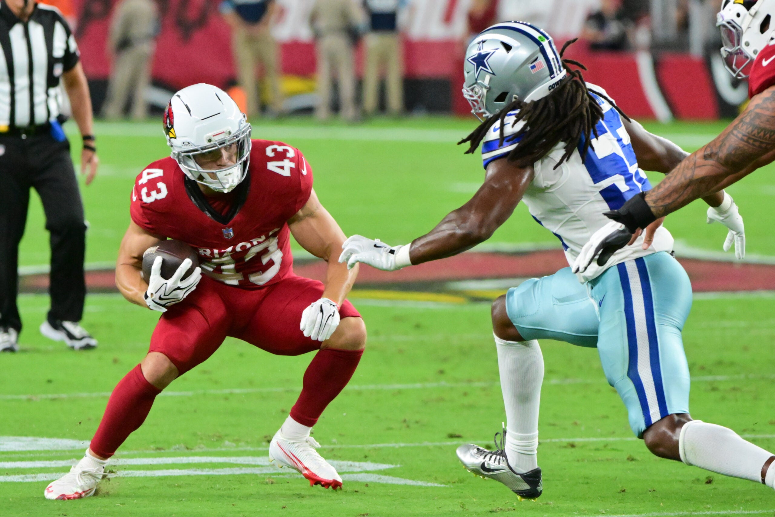 Aug 22, 2026; Glendale, Arizona, USA; Arizona Cardinals running back Evan Hull (43) runs the ball against Dallas Cowboys linebacker Jaishawn Barham (55) in the first half at State Farm Stadium.
