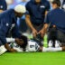 Aug 23, 2026; Nashville, Tennessee, USA; Seattle Seahawks trainer holds the ankle of safety Bud Clark (9) as they wait for the cart against the Tennessee Titans during the first half at Nissan Stadium.