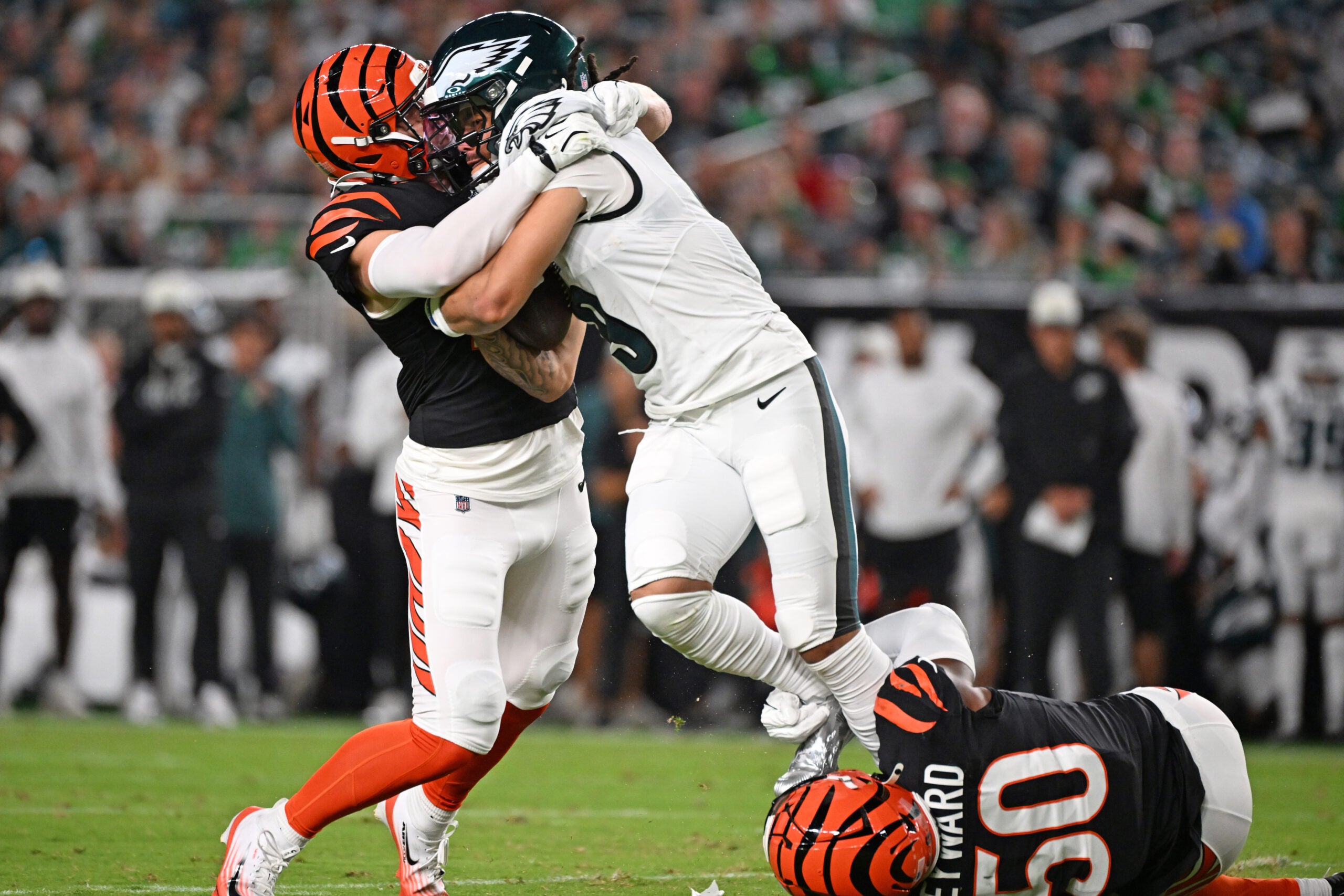 Aug 28, 2026; Philadelphia, Pennsylvania, USA; Cincinnati Bengals linebacker Swayze Bozeman (47) and linebacker Shaka Heyward (50) tackle Philadelphia Eagles wide receiver Makai Lemon (9) during the first half at Lincoln Financial Field.