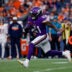 Aug 28, 2026; Denver, Colorado, USA; Minnesota Vikings running back Demond Claiborne (21) runs the ball in the first quarter against the Denver Broncos at Empower Field at Mile High.