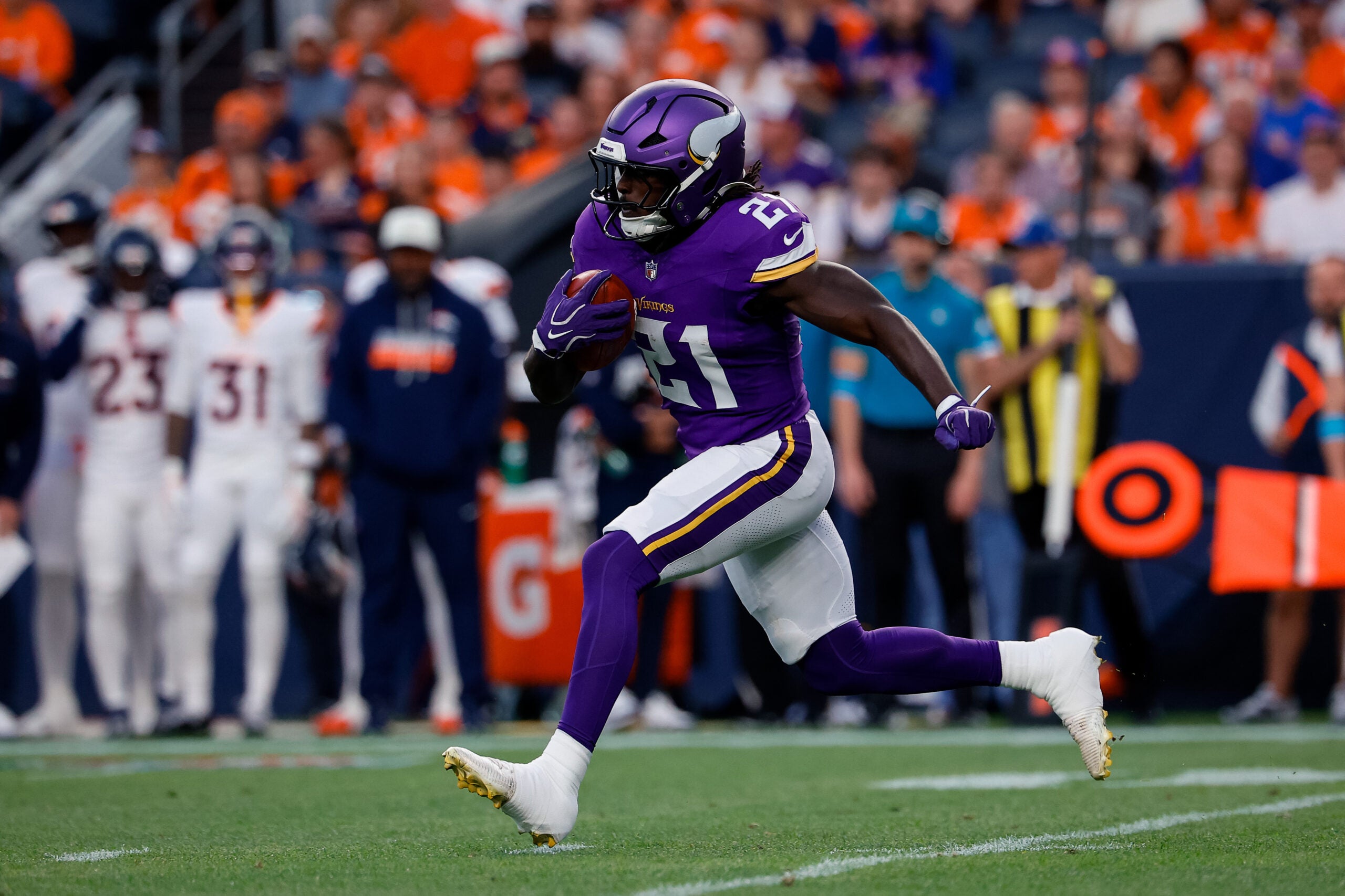 Aug 28, 2026; Denver, Colorado, USA; Minnesota Vikings running back Demond Claiborne (21) runs the ball in the first quarter against the Denver Broncos at Empower Field at Mile High.