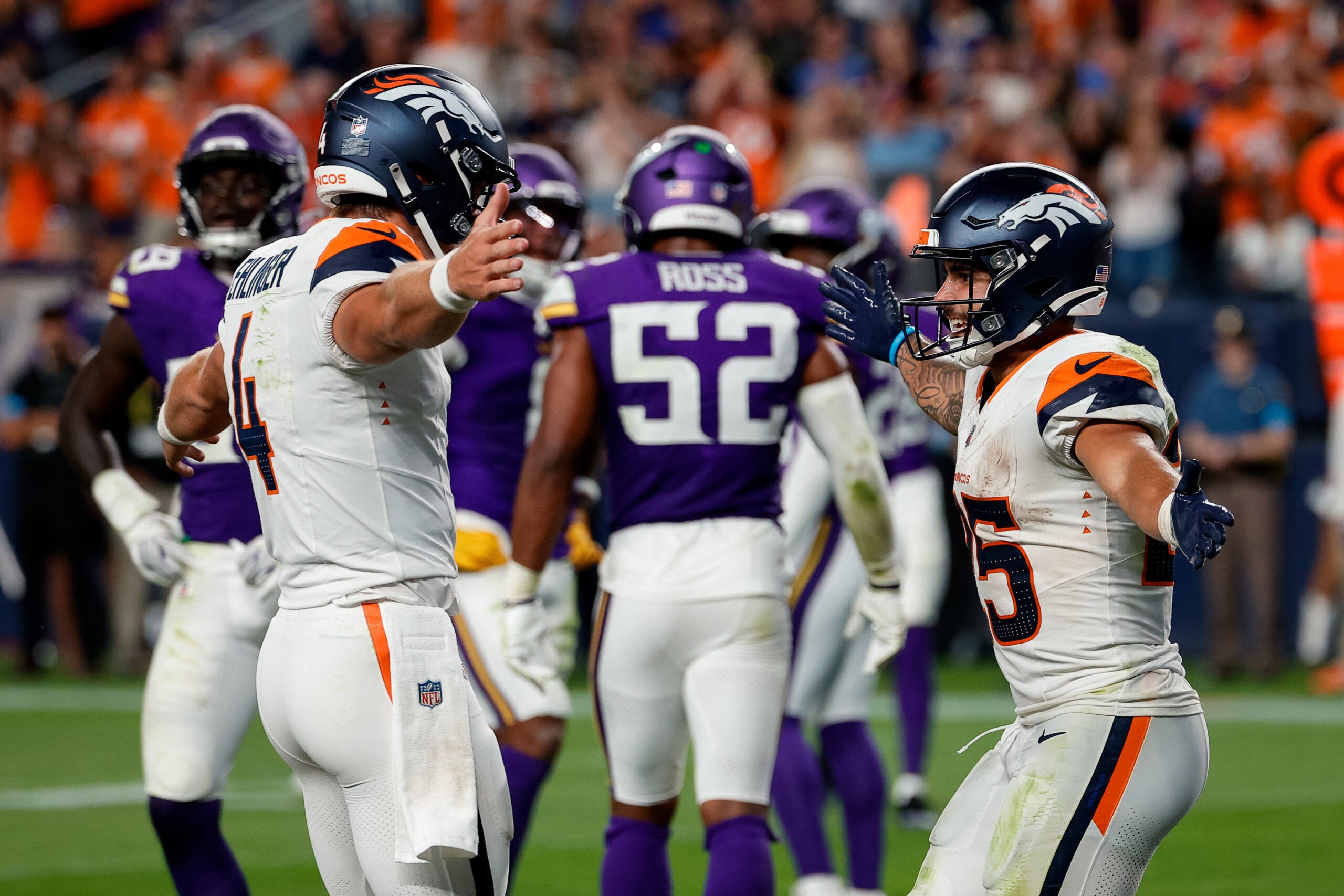 Aug 28, 2026; Denver, Colorado, USA; Denver Broncos quarterback Sam Ehlinger (4) celebrates the touchdown of running back Cody Schrader (25) in the fourth quarter against the Minnesota Vikings at Empower Field at Mile High.