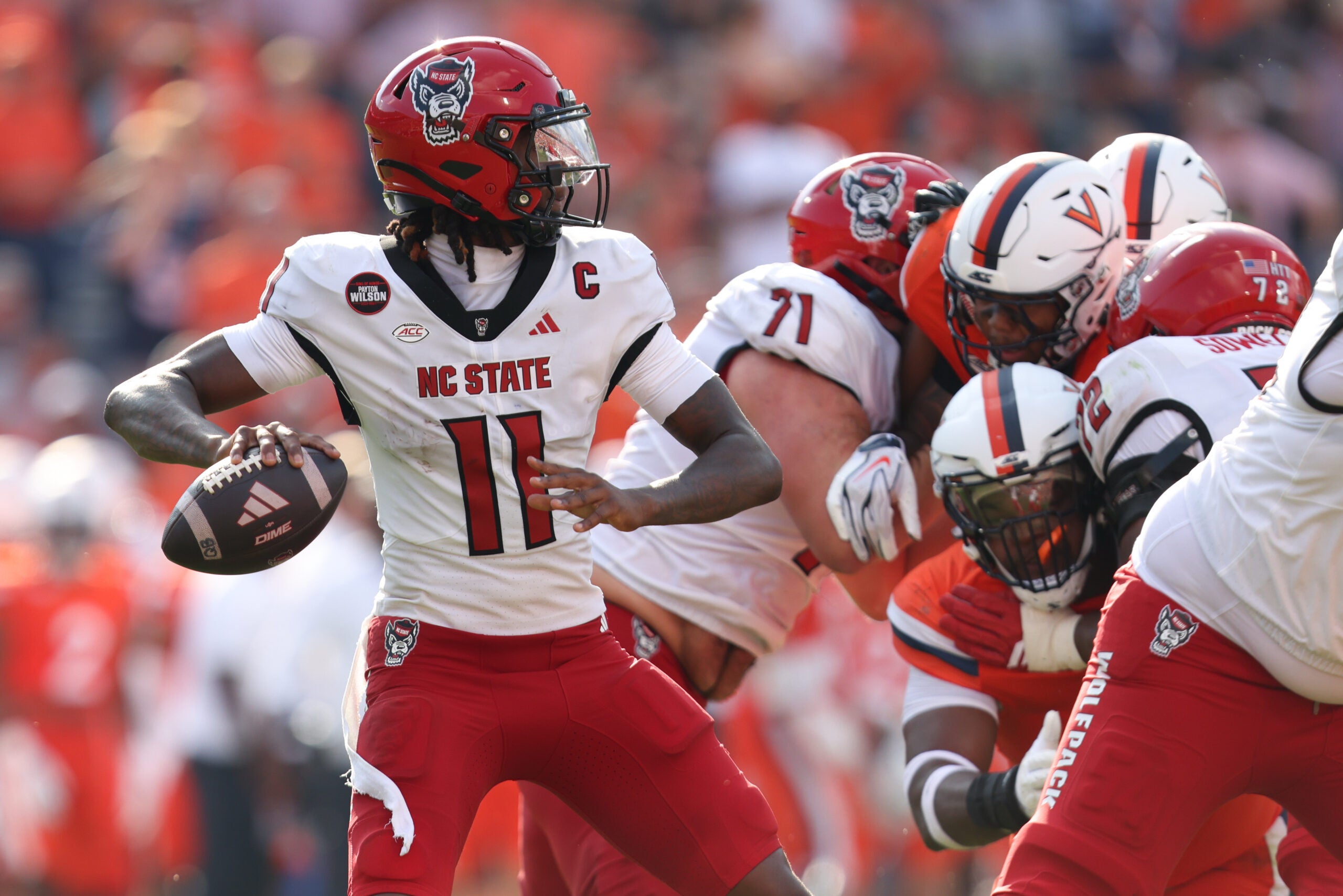 Aug 29, 2026; Charlottesville, Virginia, USA; North Carolina State Wolfpack quarterback CJ Bailey (11) passes the ball during the game against the Virginia Cavaliers at Scott Stadium.