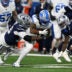Dec 4, 2025; Detroit, Michigan, USA; Detroit Lions running back Jahmyr Gibbs (0) is tackled by Dallas Cowboys defensive tackle Quinnen Williams (92) during the first half at Ford Field.