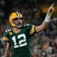 Green Bay Packers quarterback Aaron Rodgers (12) celebrates after rushing for a first down during the fourth quarter of their game against the Chicago Bears on Sunday, Sept. 18, 2022 at Lambeau Field in Green Bay.
