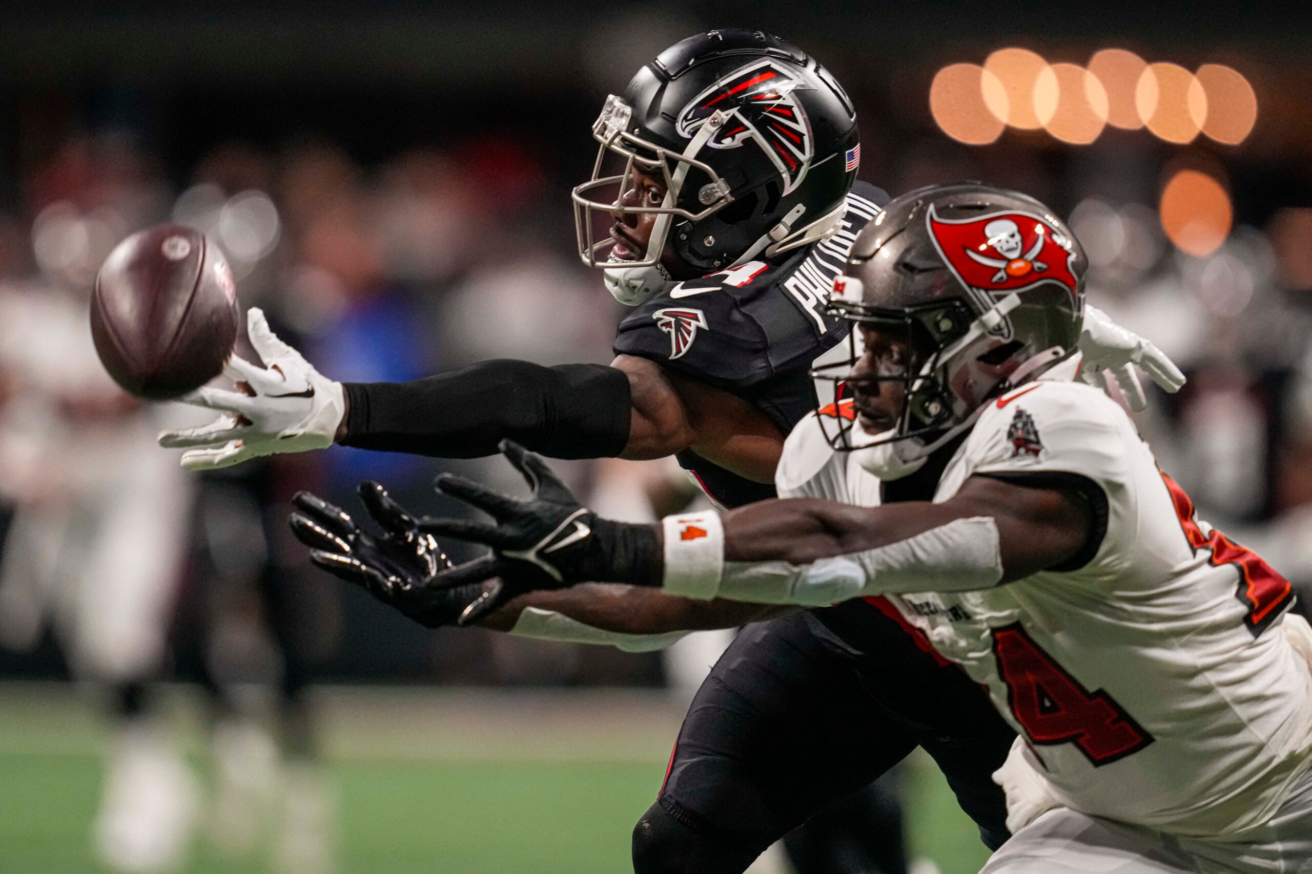 Dec 10, 2023; Atlanta, Georgia, USA; Atlanta Falcons cornerback Clark Phillips III (34) deflects a pass away from Tampa Bay Buccaneers wide receiver Chris Godwin (14) during the first half at Mercedes-Benz Stadium.