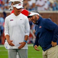 Sep 21, 2024; Oxford, Mississippi, USA; Mississippi Rebels head coach Lane Kiffin (left) shares a laugh with defensive coordinator Pete Golding (right) during warm ups prior to the game against the Georgia Southern Eagles at Vaught-Hemingway Stadium.