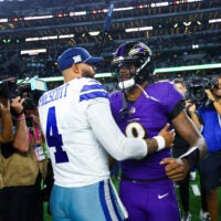 Sep 22, 2024; Arlington, Texas, USA; Dallas Cowboys quarterback Dak Prescott (4) hugs Baltimore Ravens quarterback Lamar Jackson (8) after the game at AT&T Stadium.