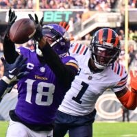 Nov 24, 2024; Chicago, Illinois, USA; Chicago Bears defensive back Jonathan Owens (36) is called for pass interference as he intercepts a pass intended for Minnesota Vikings wide receiver Justin Jefferson (18) during the second quarter at Soldier Field.