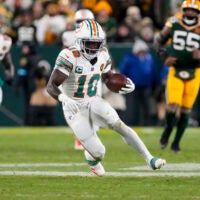 Nov 28, 2024; Green Bay, Wisconsin, USA; Miami Dolphins wide receiver Tyreek Hill (10) rushes with the football during the fourth quarter against the Green Bay Packers at Lambeau Field.