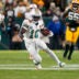 Nov 28, 2024; Green Bay, Wisconsin, USA; Miami Dolphins wide receiver Tyreek Hill (10) rushes with the football during the fourth quarter against the Green Bay Packers at Lambeau Field.