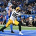 Dec 5, 2024; Detroit, Michigan, USA; Green Bay Packers tight end Tucker Kraft (85) spikes the ball after catching a touchdown pass against the Detroit Lions in the third quarter at Ford Field.