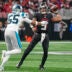 Jan 5, 2025; Atlanta, Georgia, USA; Atlanta Falcons quarterback Michael Penix Jr. (9) passes over Carolina Panthers defensive end Kenny Dyson Jr. (55) during the first quarter at Mercedes-Benz Stadium.