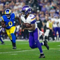 Jan 13, 2025; Glendale, AZ, USA; Minnesota Vikings running back Cam Akers (27) against the Los Angeles Rams during an NFC wild card game at State Farm Stadium.