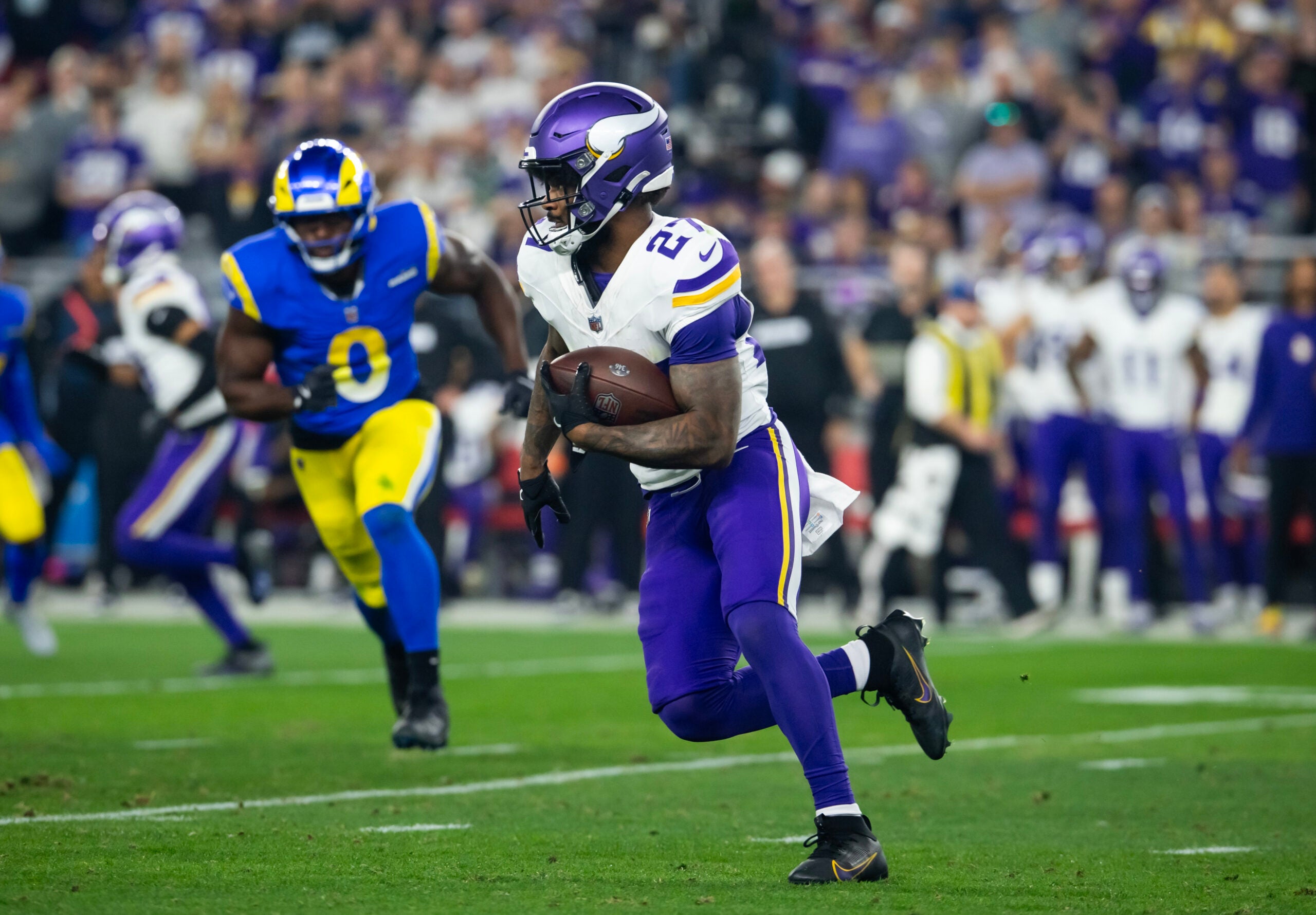 Jan 13, 2025; Glendale, AZ, USA; Minnesota Vikings running back Cam Akers (27) against the Los Angeles Rams during an NFC wild card game at State Farm Stadium.