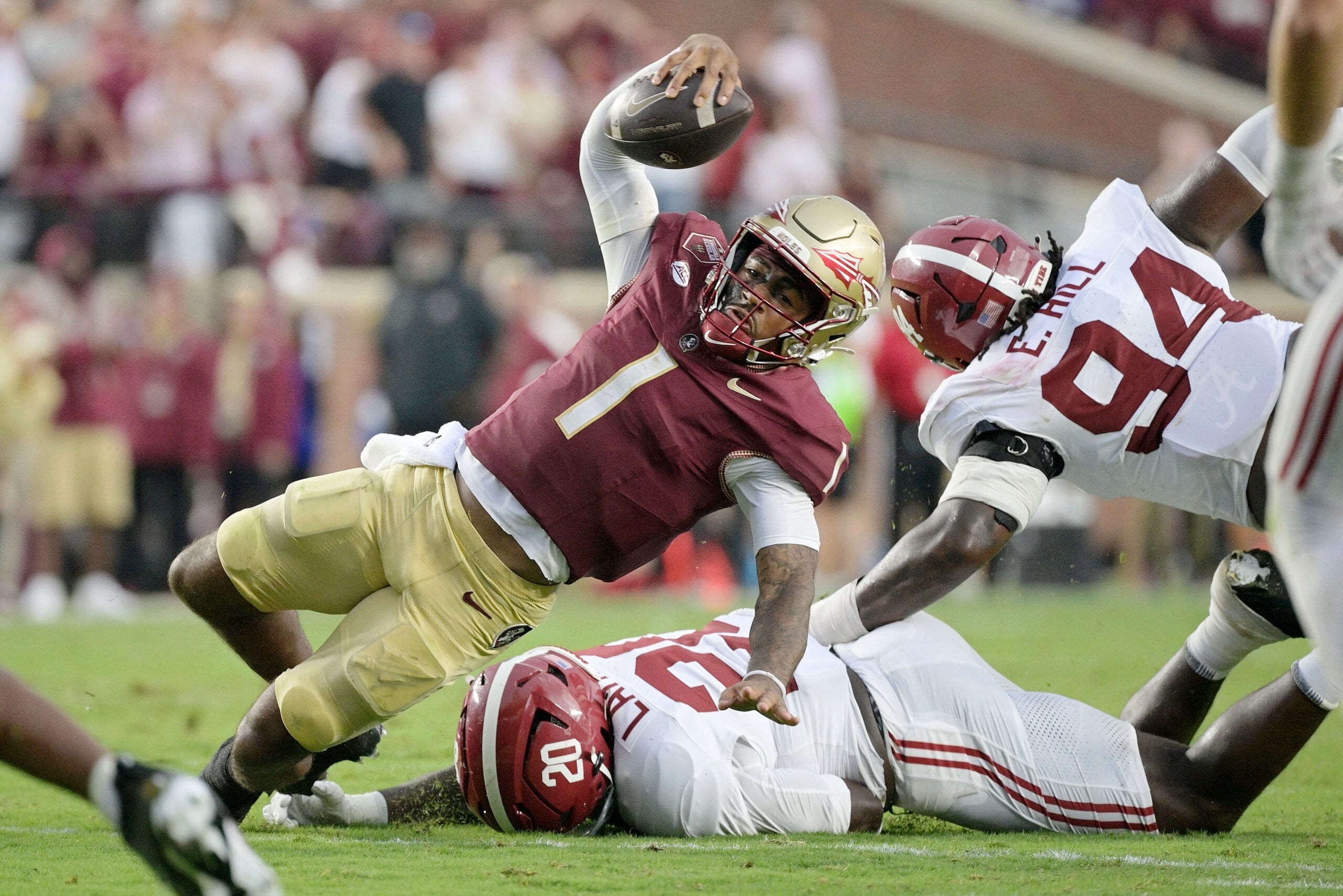 Aug 30, 2025; Tallahassee, Florida, USA; Florida State Seminoles quarterback Tommy Castellanos (1) loses his footing against Alabama Crimson Tide linebacker Jah-Marien Latham (20) during the second half at Doak S. Campbell Stadium.