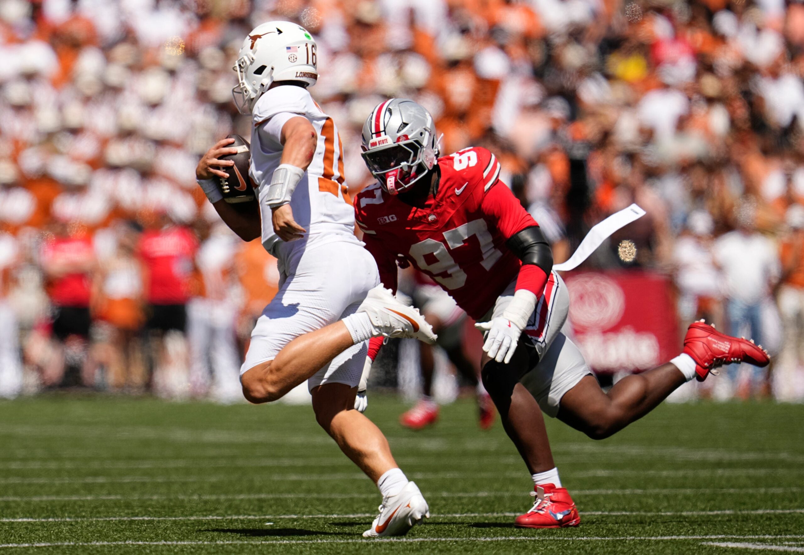 Ohio State Buckeyes defensive end Kenyatta Jackson Jr. (97) chases Texas Longhorns quarterback Arch Manning (16) during the NCAA football game at Ohio Stadium on Aug. 30, 2025.