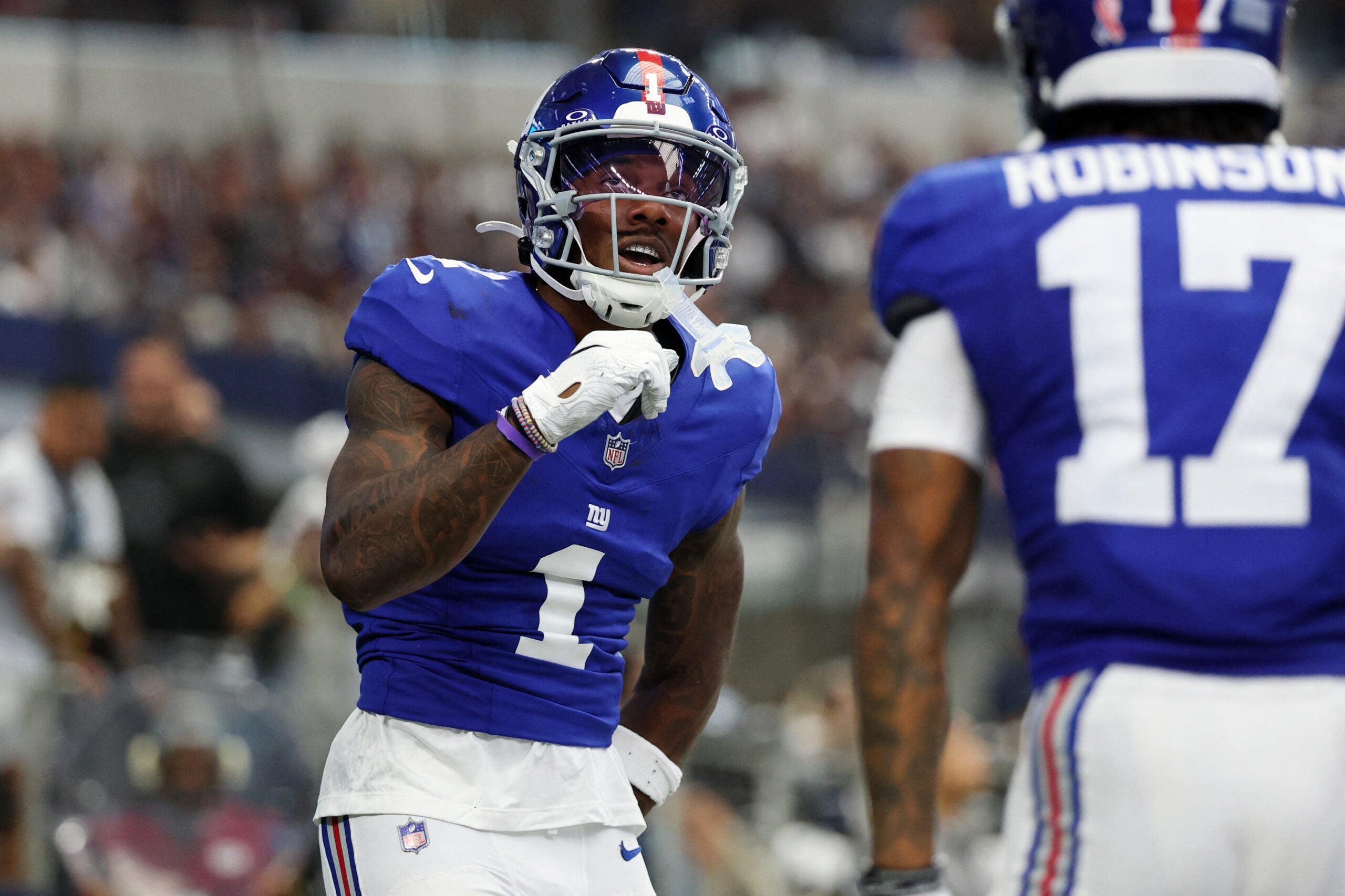 Sep 14, 2025; Arlington, Texas, USA; New York Giants wide receiver Malik Nabers (1) celebrates after scoring a touchdown against the Dallas Cowboys during the second quarter at AT&T Stadium.