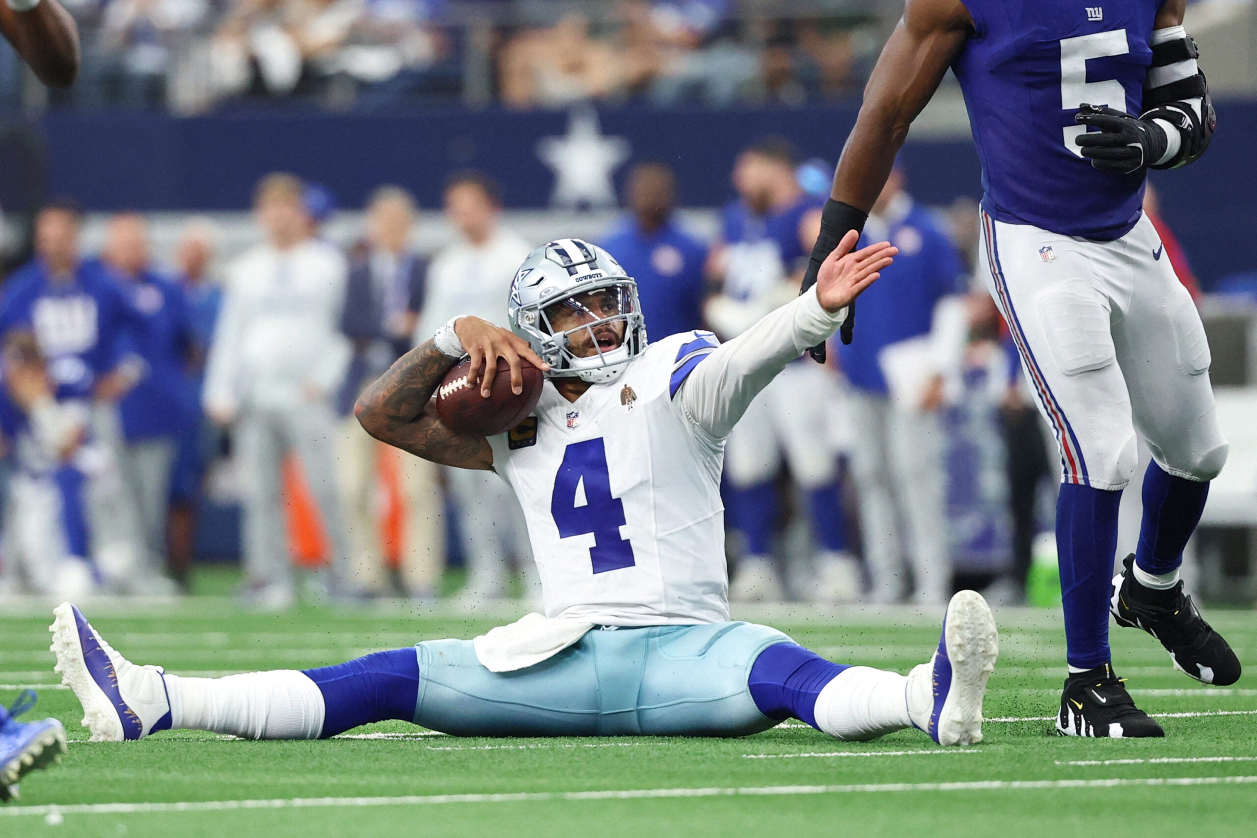 Sep 14, 2025; Arlington, Texas, USA; Dallas Cowboys quarterback Dak Prescott (4) reacts after a play against the New York Giants during overtime at AT&T Stadium.