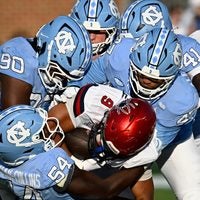 Sep 13, 2025; Chapel Hill, North Carolina, USA; North Carolina Tar Heels defensive lineman Xavier Lewis (90) and linebackers Timir Hickman-Collins (54) and Austin Alexander (47) tackle Richmond Spiders running back Michael Creamer (9) in the fourth quarter at Kenan Stadium.