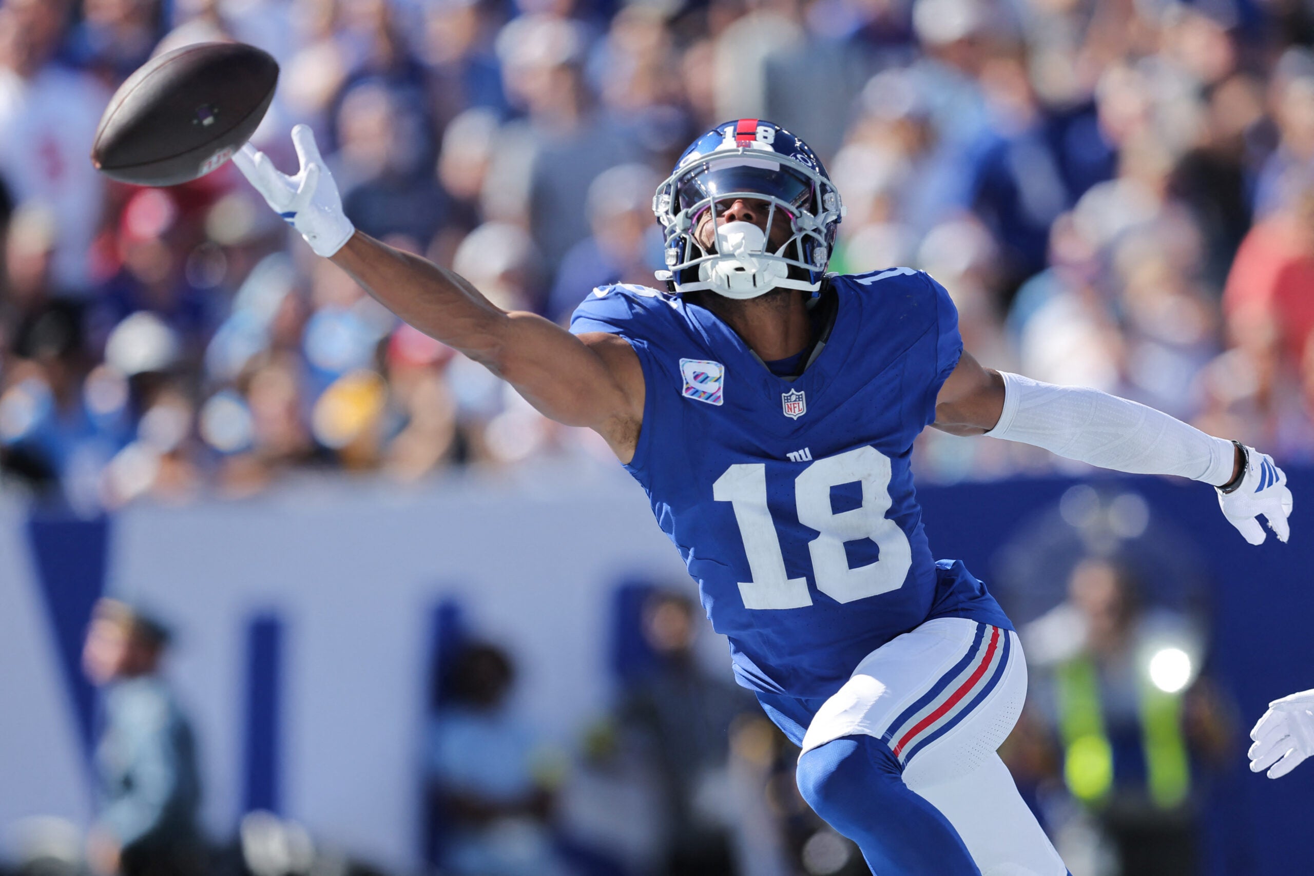 Sep 28, 2025; East Rutherford, New Jersey, USA; New York Giants wide receiver Darius Slayton (18) attempts to make a catch during the second quarter against the Los Angeles Chargers at MetLife Stadium.